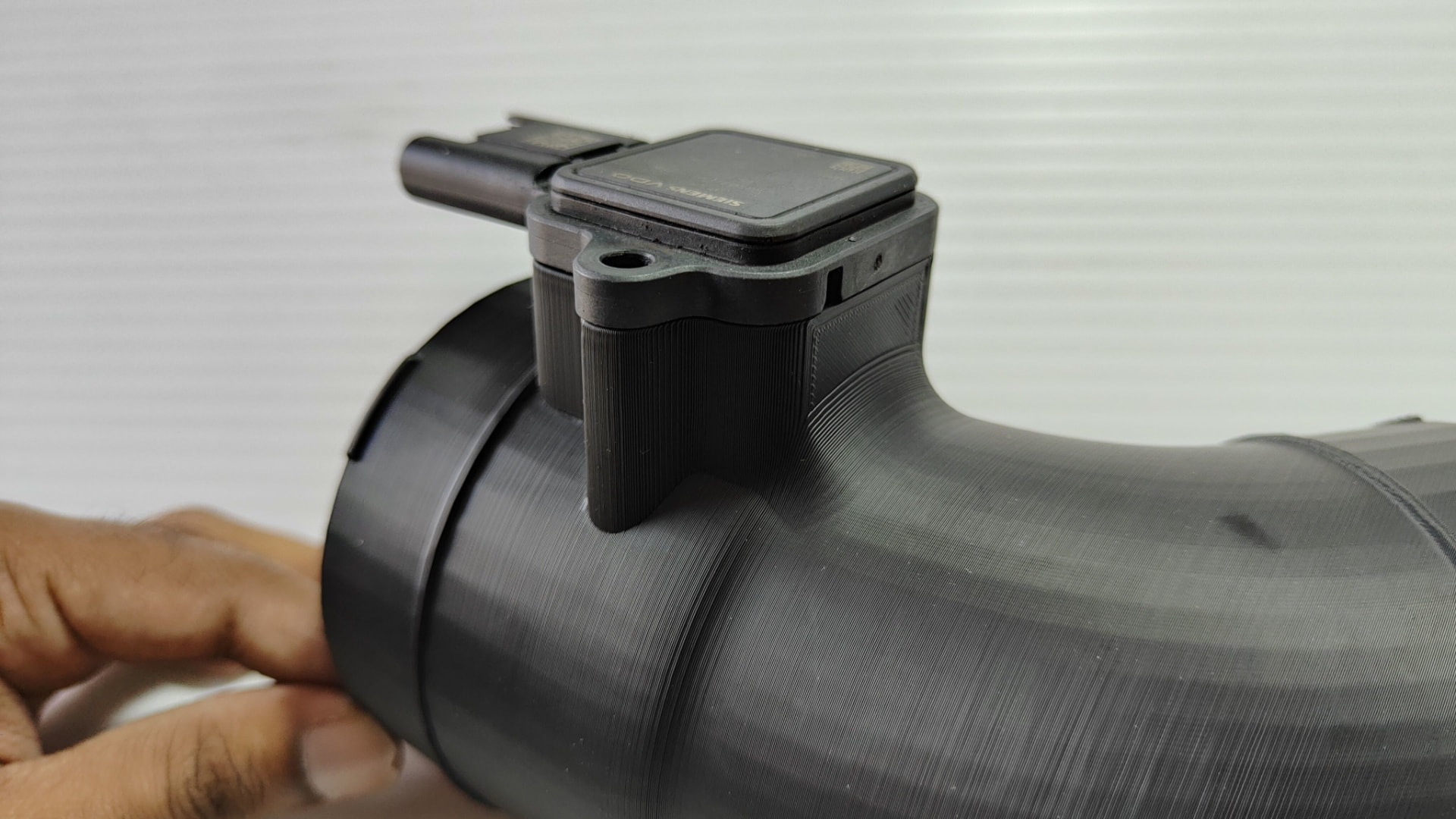 Close-up of the MAF sensor housing on the FIXHEN N52 intake adapter